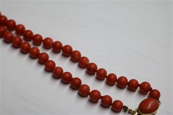 A single strand graduated coral bead necklace, with yellow metal clasp, gross weight 53 grams, 64cm.